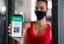 Time to Fly: The lowdown on COVID Passports woman-with-vaccination-certificate-app-on-smartpho