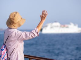 rear-view-of-senior-woman-with-hat-looking-at-ferr-2024-11-02-22-48-16-utc