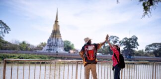 Why Gen Z Are Cutting Back on Everything Except Travel traveler tourist man and women with backpack walking