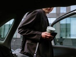 business person getting into a car