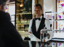 bartender standing in front of customer