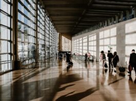 people walking with suitcases in airport