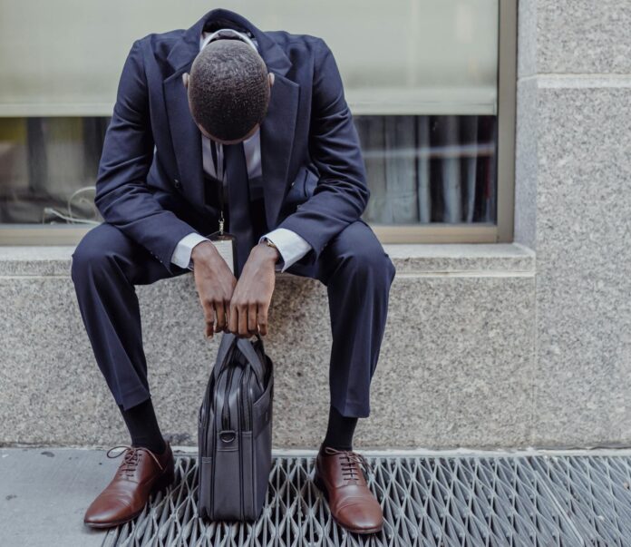 pexels-mizunokozuki-13801996 (1) man sitting with briefcase
