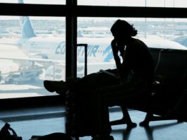 person sitting at airport waiting for flight