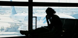 FCM warns SA Corporates – Book Now as Middle East Crisis Drives Capacity Crunch and Soaring Fares person sitting at airport waiting for flight