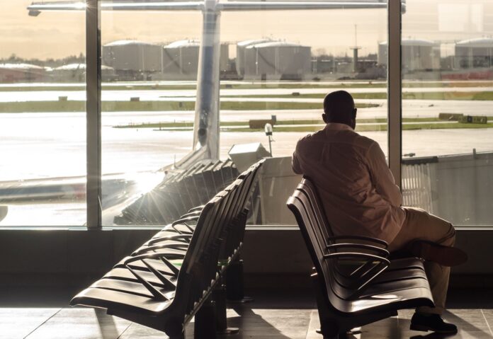 man sitting on chairs at the airport