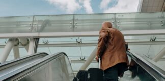 South African business trips just got 65% longer business man on escalator with luggage